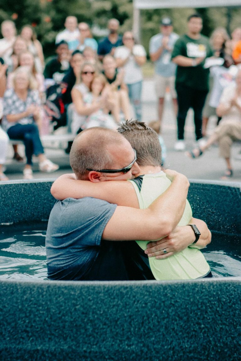 Baptism ceremony with hug, celebrating faith in Clemson, SC.